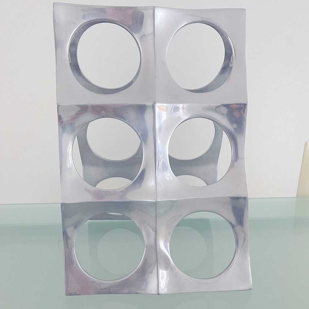 Lunares designer ART wine bottle holder in stainless steel.